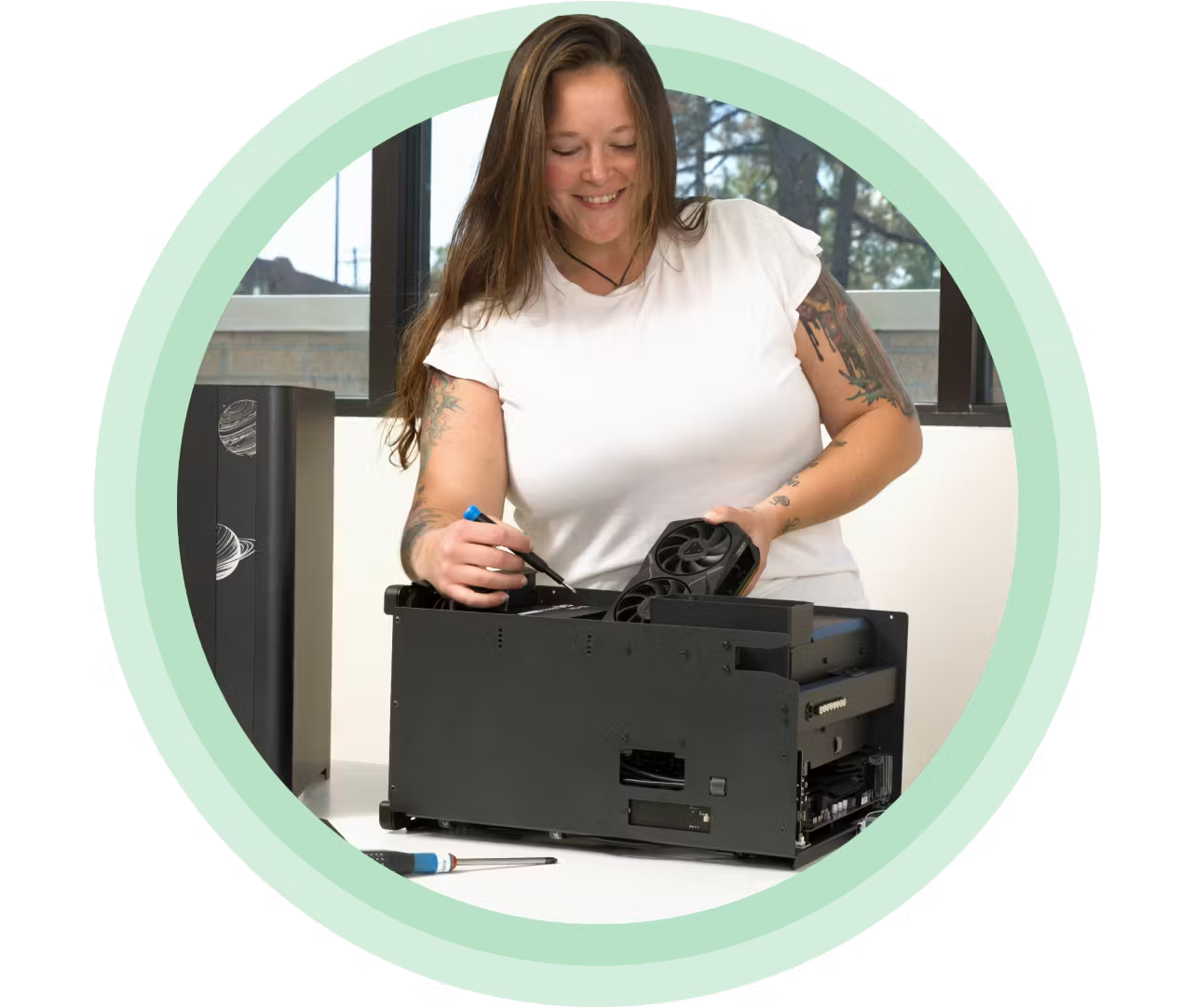 Woman building a PC from a System76 Thelio case.