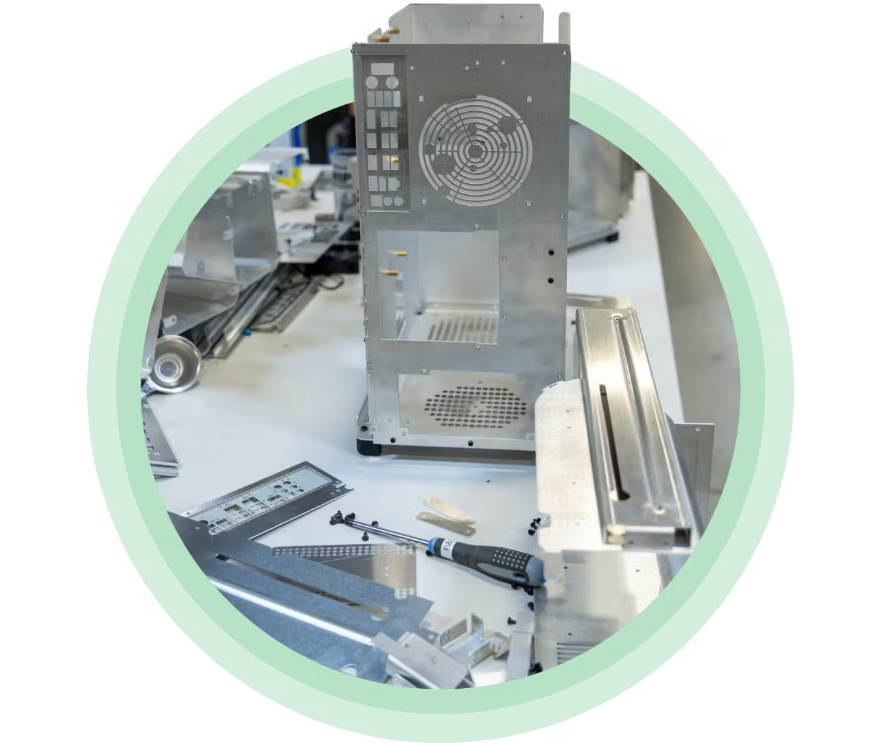 Unpainted aluminum parts manufactured at the System76 factory on a workbench.